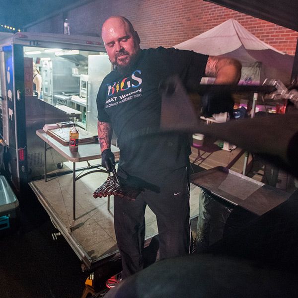 Joe McQain, owner of Bigs Meat Wagon, removes a slab of ribs from the smoker at the 2017 Loveland Fire and Ice Festival, Friday Feb. 10, 2017.
